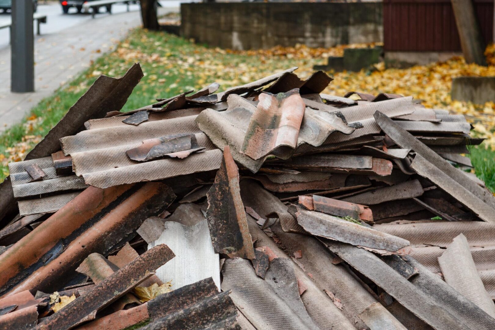 Pile of discarded corrugated roofing sheets.
