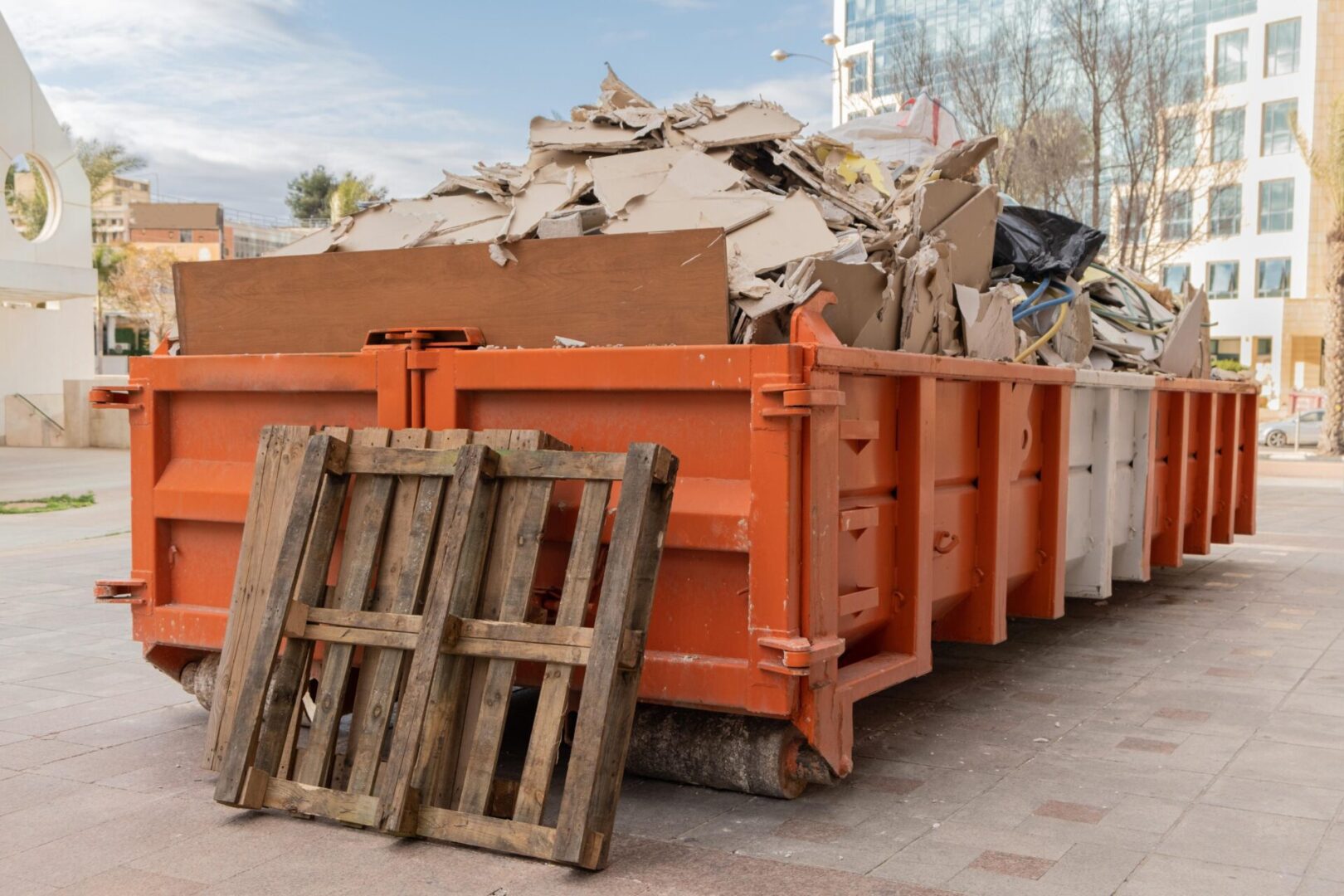 Dumpster filled with cardboard and debris.