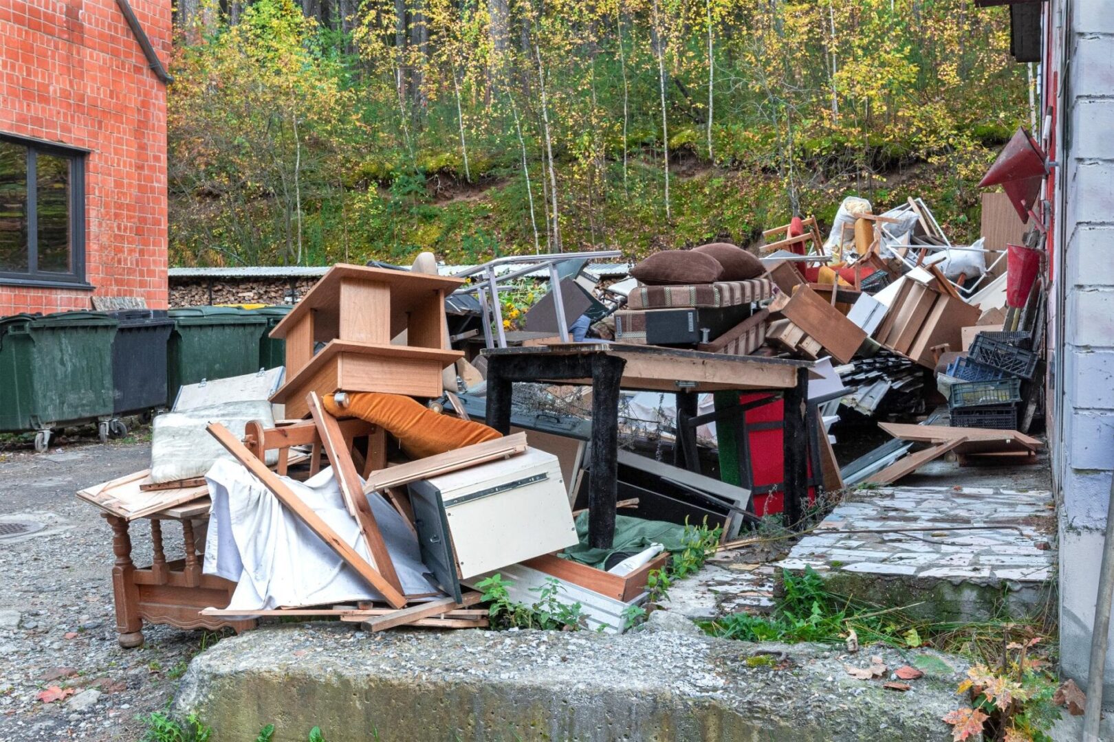 Piled discarded furniture and debris outside.